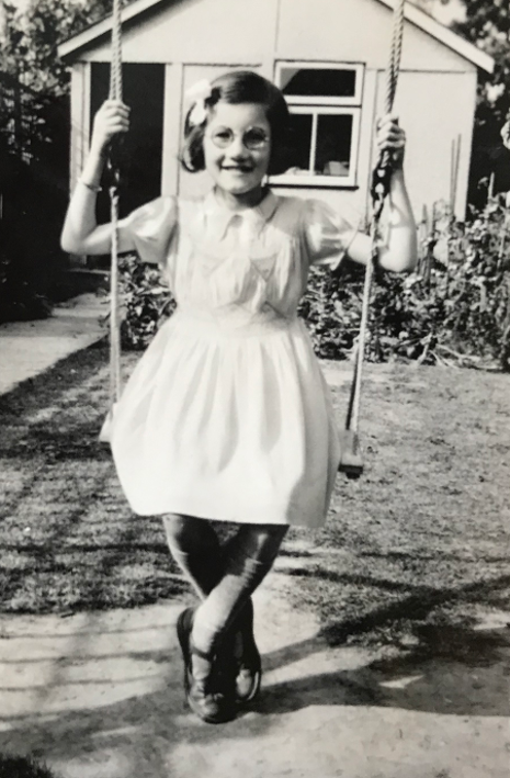 Margaret in front of her family's garden