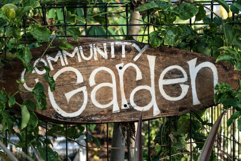 A sign announcing a community garden space