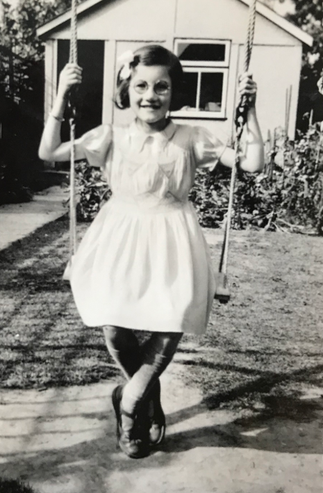 Margaret Jackson, on a swing, in WWII Britain